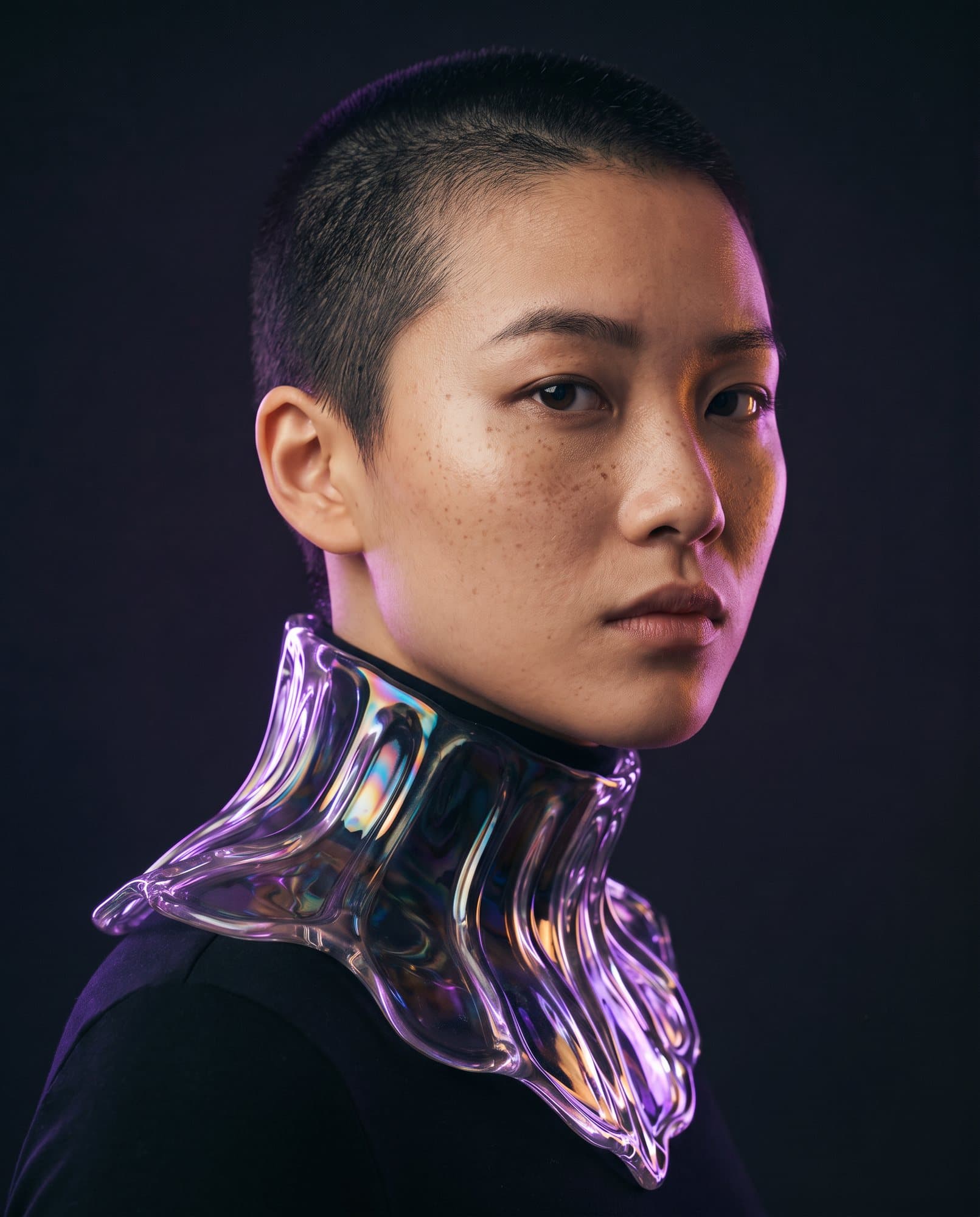 Editorial portrait of a model in an iridescent liquid-glass collar